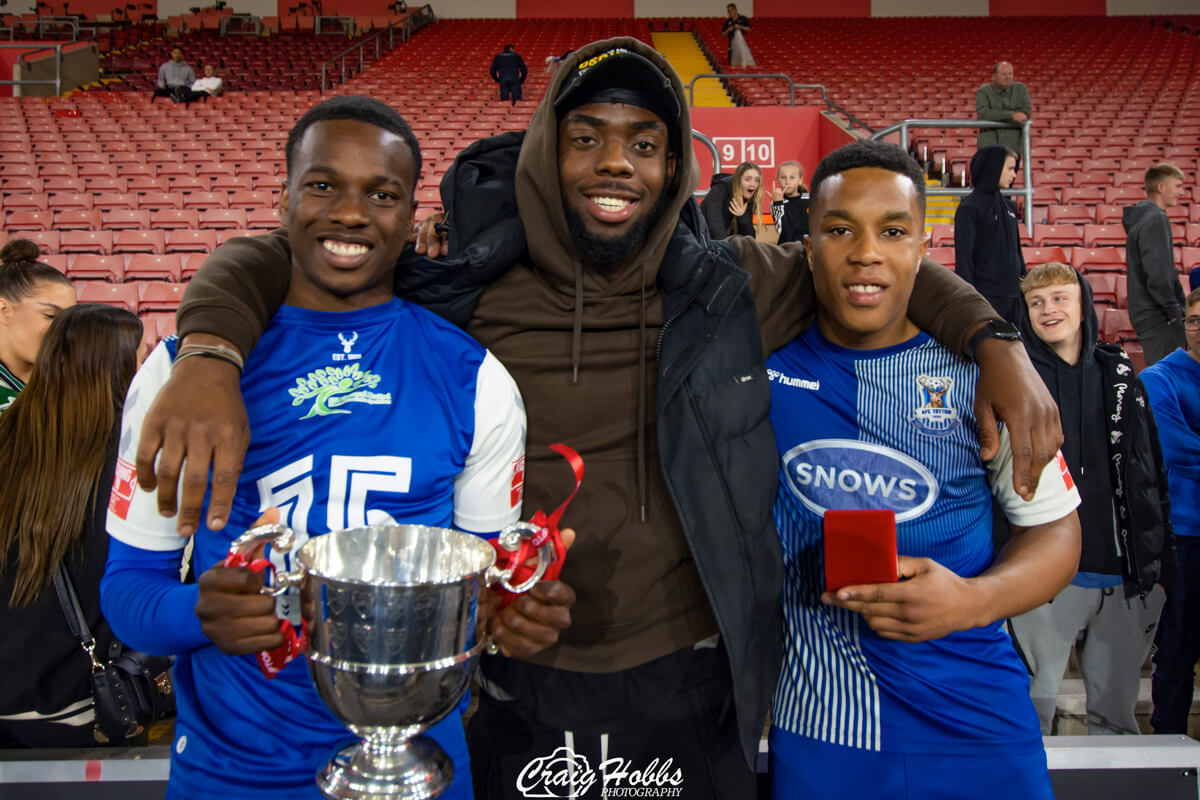 Shaquille Gwengwe with trophy_Silvano Obeng_Jordan Ragguette_Post-Match Celebrations_AFC Totton vs Folland Sports_St Marys Stadium_SSC Final_Thu05May22.jpg