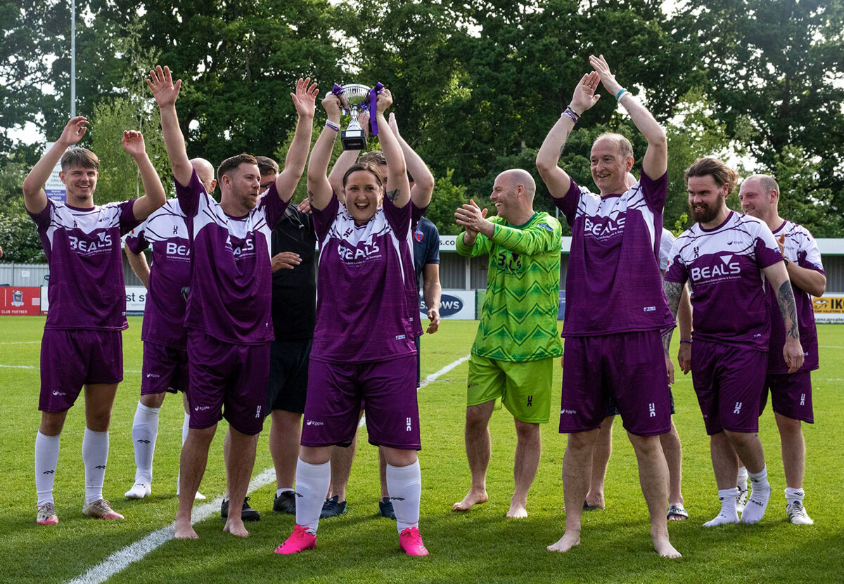 Alice Hendy lifts Trophy-1_Joshs Game_Ripple Suicide Prevention_Sat21May22.jpg